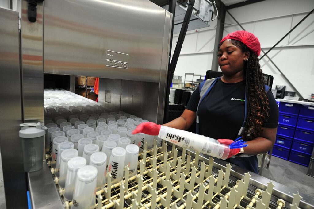 girl washing reusable cups