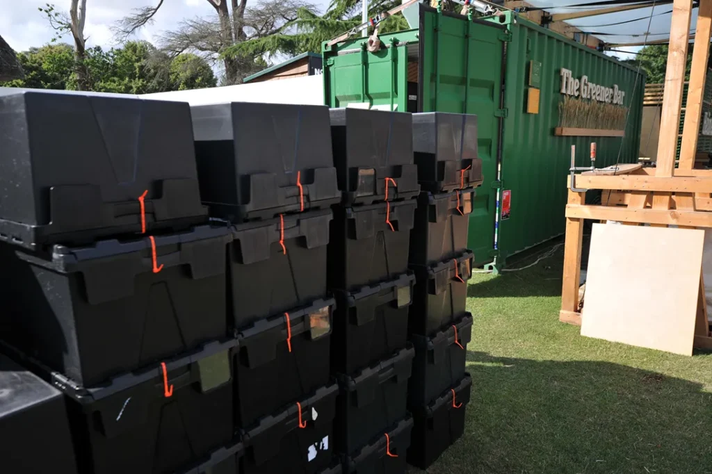 tote boxes of reusable cups on site