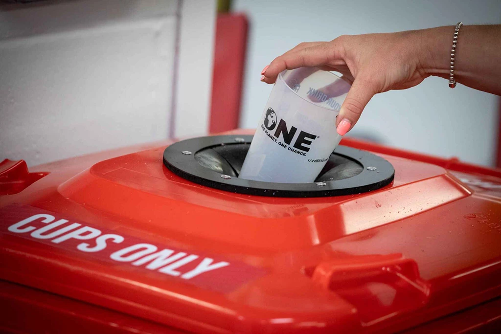 reusable cup into a reusable cup bin